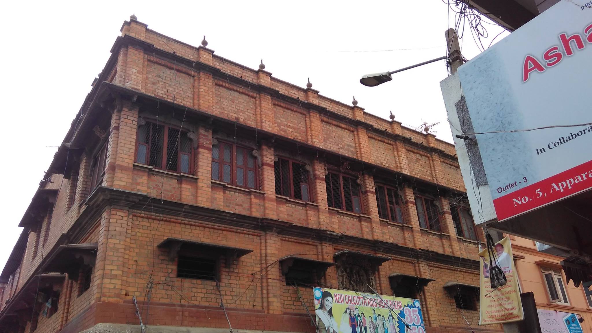 Solid, old architecture in the middle of a bustling lane