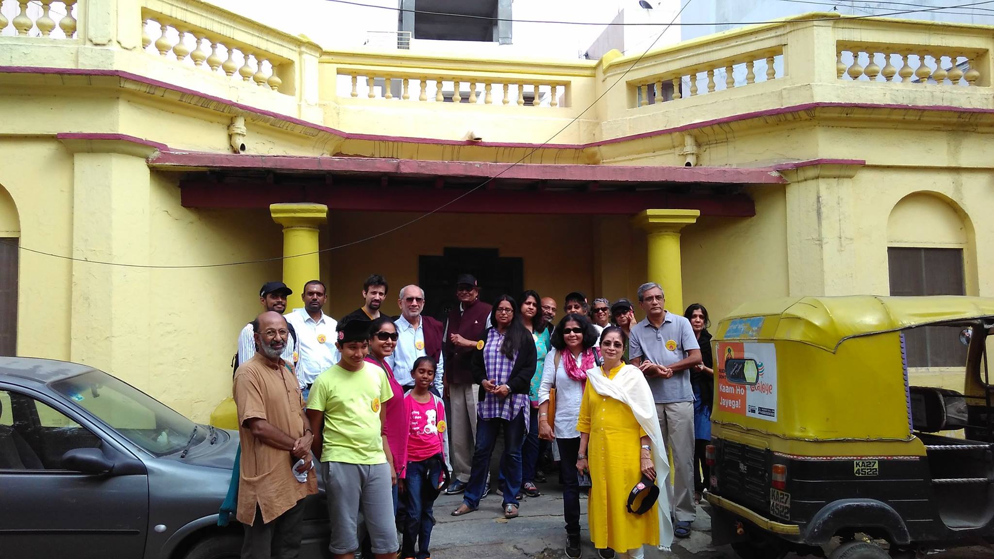 The enthusiastic walkers pose before an almost colonial era building