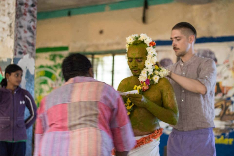 Members of the audience decorate Bhuvanesh as part of his performance piece 'Healing'. Project 560: Art Adda at Sree Vinayaka Kalyana Mantapa, Bellary Road