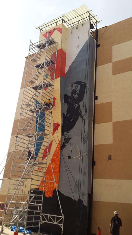 Painting of a mural on the 50 ft climbing wall at Phoenix Mall as part of Mallika Prasad & Ram Ganesh Kamatham's intervention at the space. Project 560: Mall-Wall, Phoenix Market City, Whitefield Road