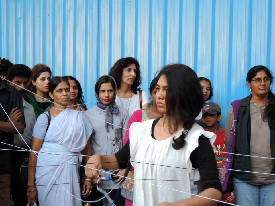 Five students of Chitra Kala Parishath - Amulya Shivakumar, Diana Aron, Shalini A, Vidhya Shree J and Varsha V, wove pieces of string around audience members until everyone was tangled up in string. Project 560: Basavanagudi Live Art Project, Ramakrishna Ashrama Circle